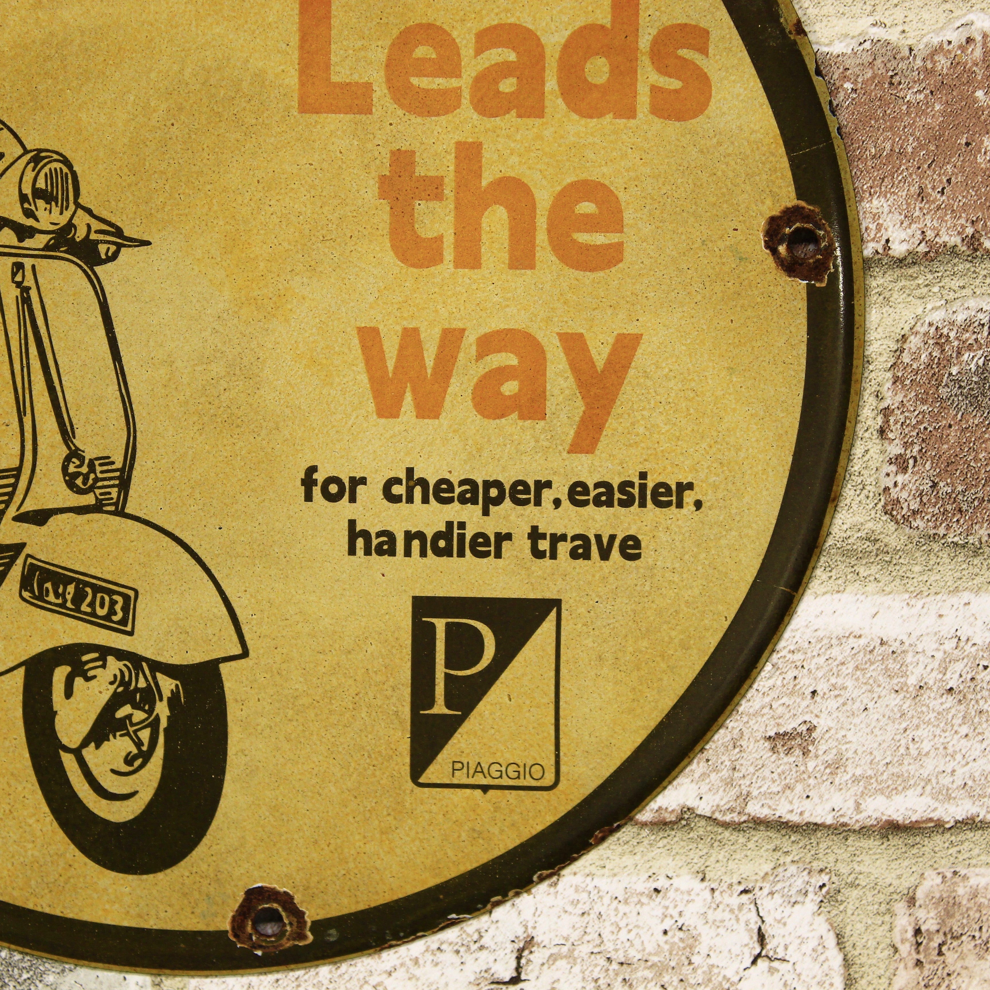 Vespa Leads the Way Porcelain Enamel Sign (12in)