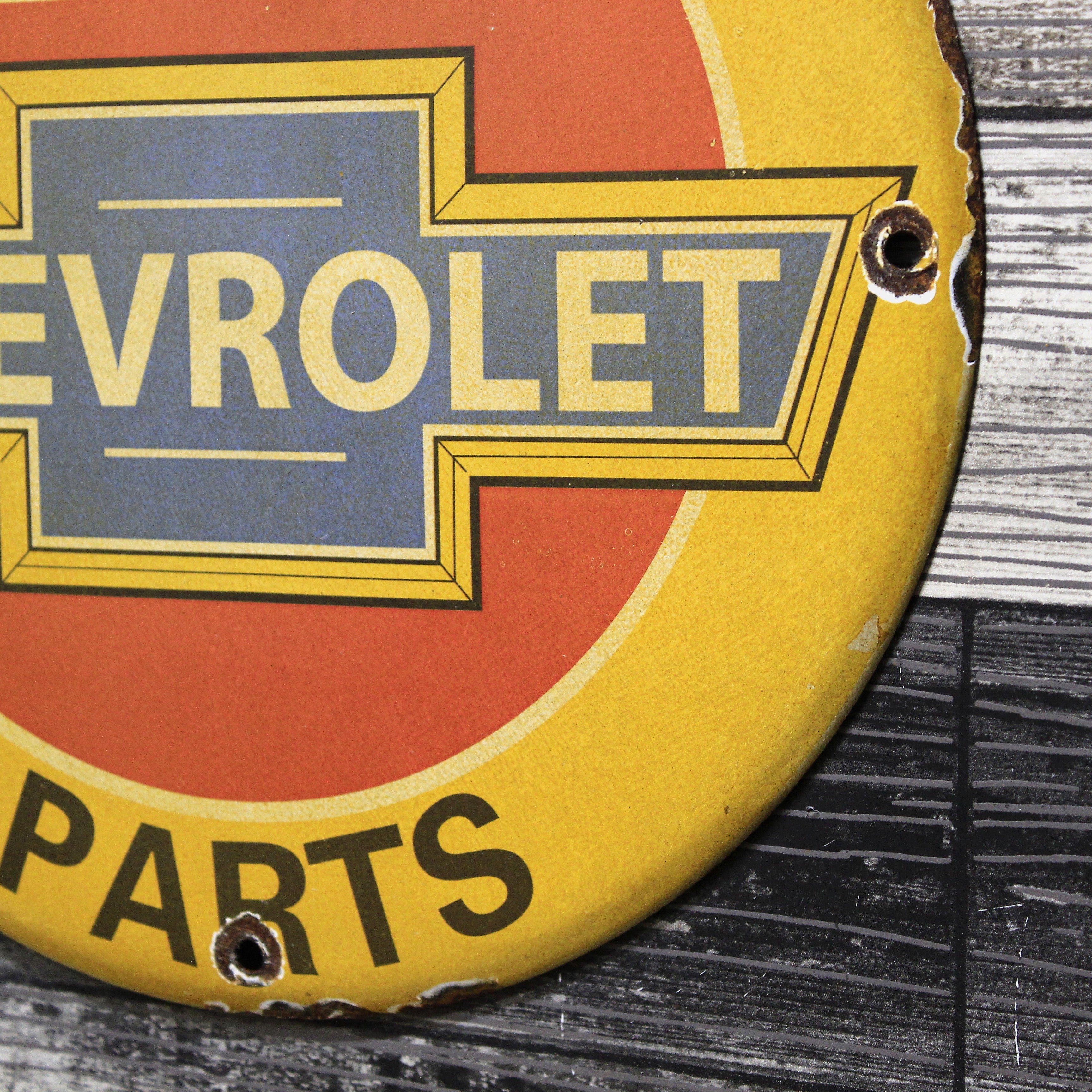We Use Chevrolet Parts Porcelain Enamel Sign (12in)