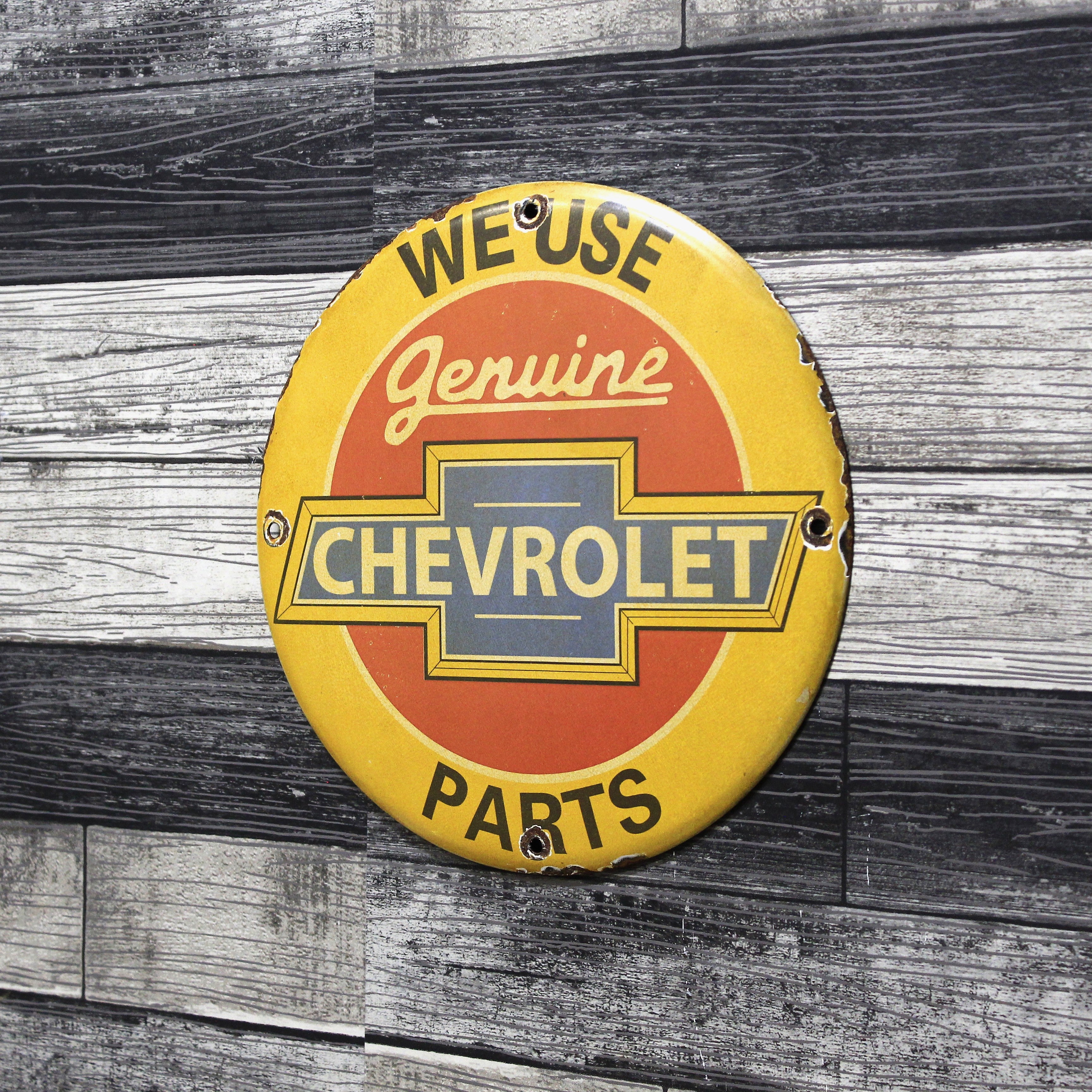 We Use Chevrolet Parts Porcelain Enamel Sign (12in)