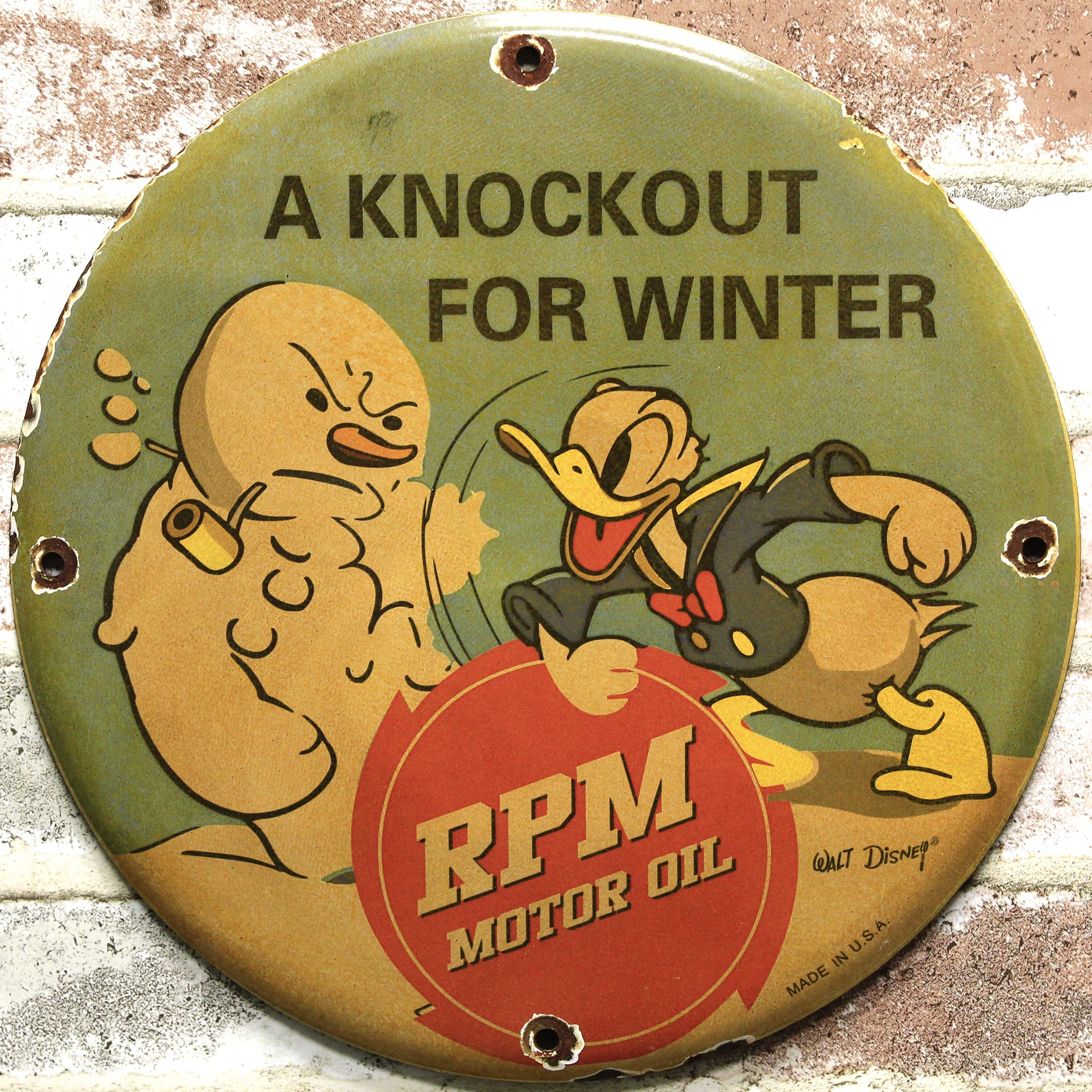 RPM Motor Oil Donald Duck Knockout for Winter Porcelain Enamel Sign (12in)