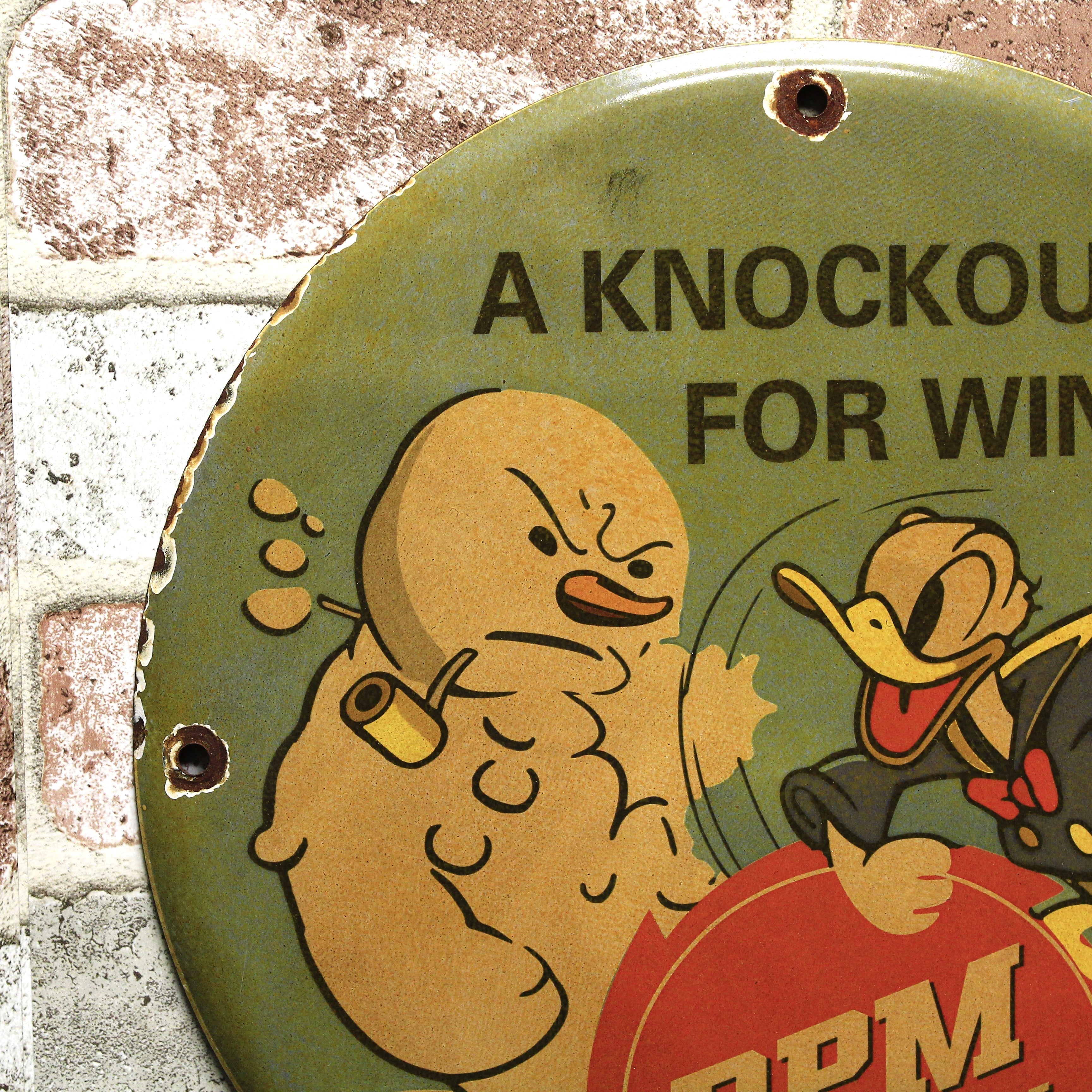 RPM Motor Oil Donald Duck Knockout for Winter Porcelain Enamel Sign (12in)
